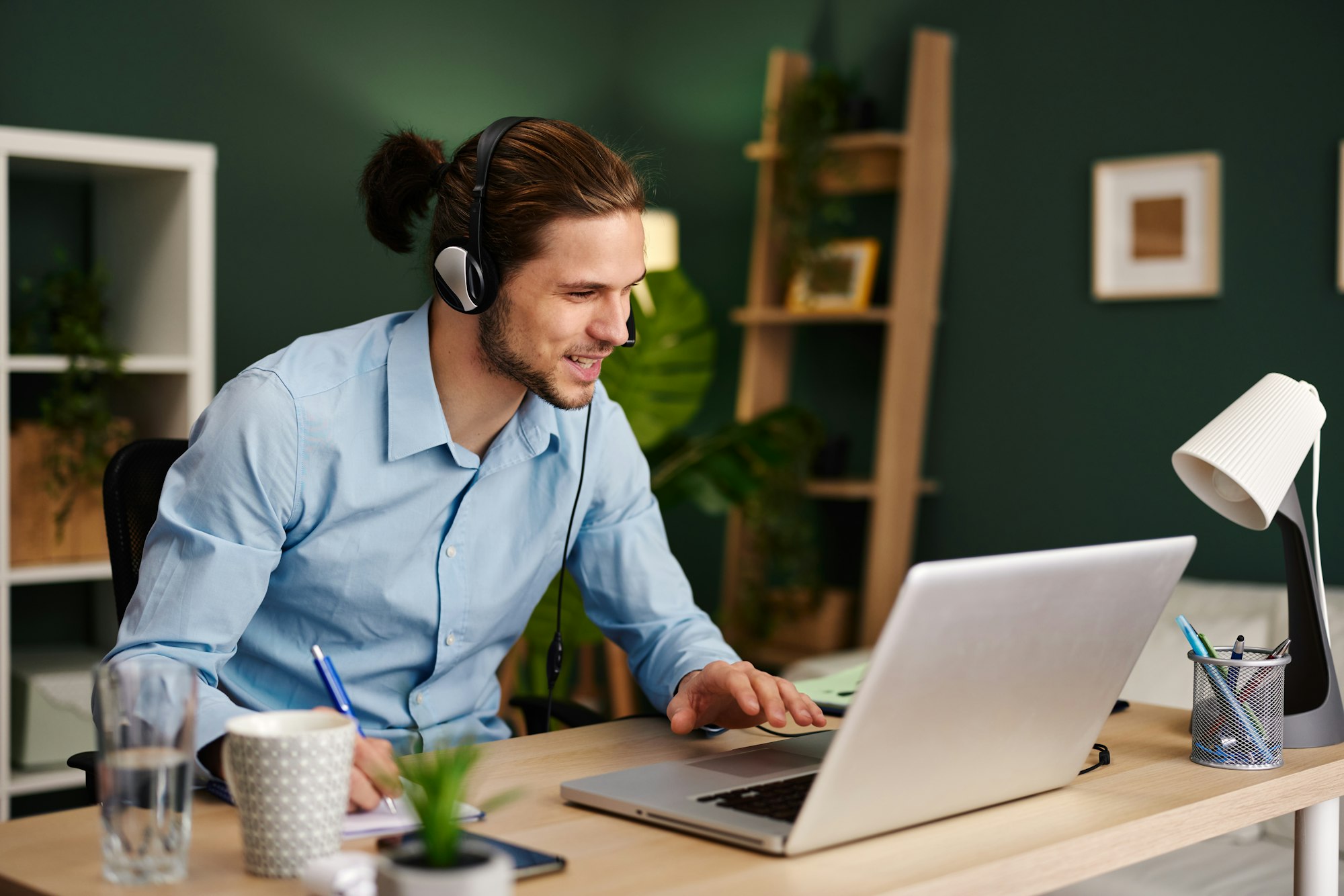 Young man working as customer support in the office