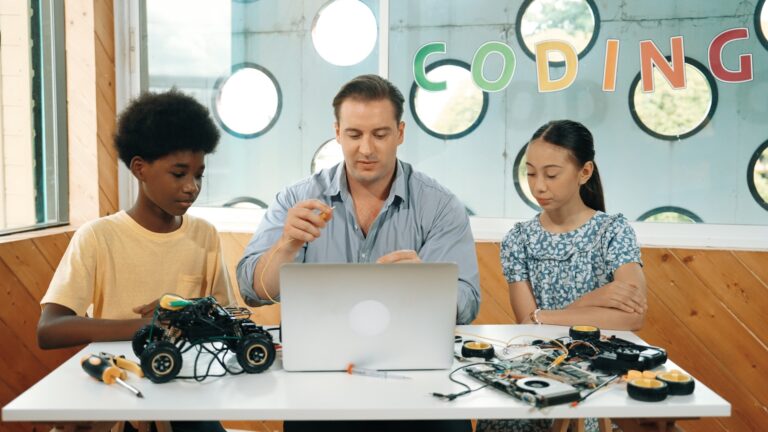 Students building electronics with an instructor