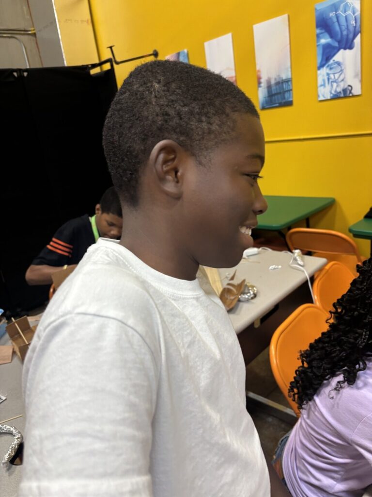 Smiling student at a STEMCAT hands-on workshop