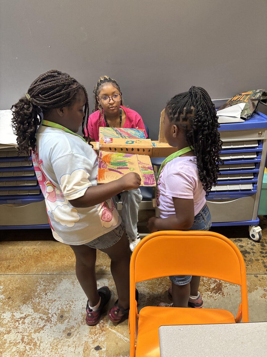 Two students working together on a cardboard build