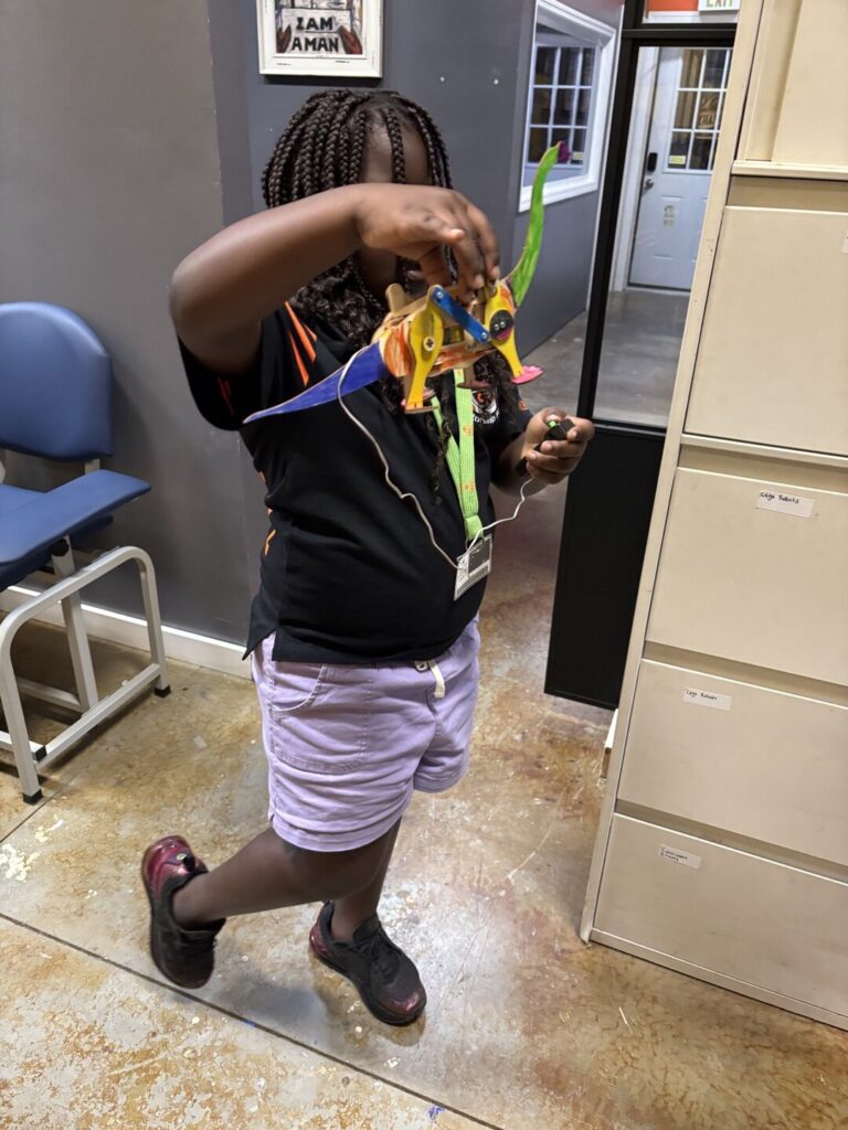 Student holding up a model she built