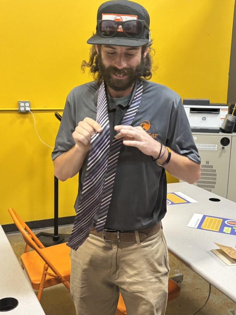 Instructor demonstrating how to tie a tie
