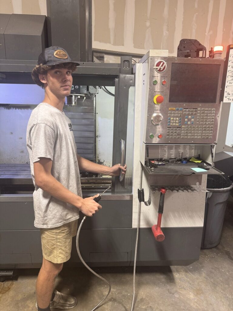 Student at the controls of a CNC machine