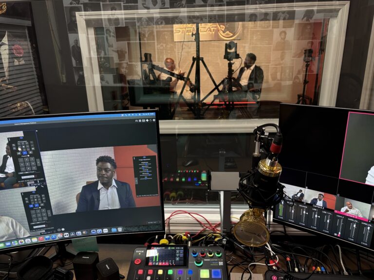 STEMCAT podcast studio control room with live camera feeds and a mixer